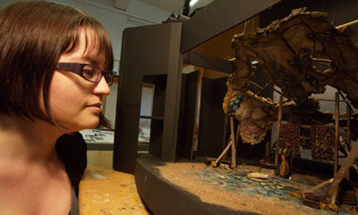 Set Designer looking at a model of her design